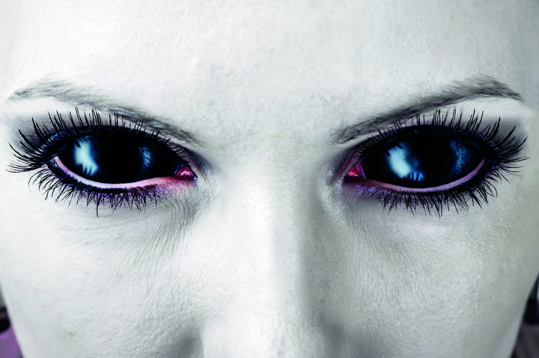 Evil black female alien, vampire or zombie eyes. dirt make up. Macro. Halloween theme